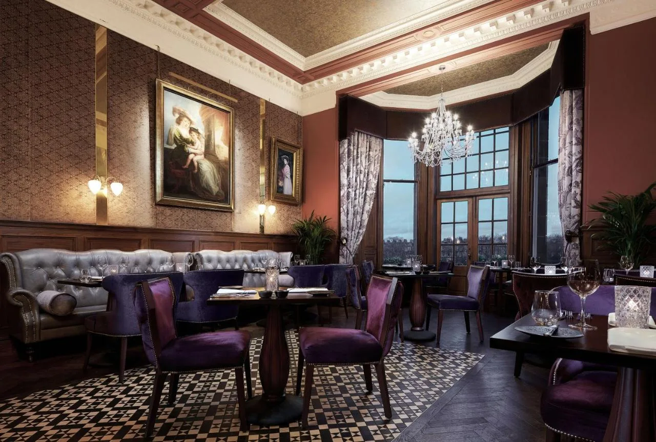 a restaurant with purple chairs and tables and a chandelier at The Bonham in Edinburgh