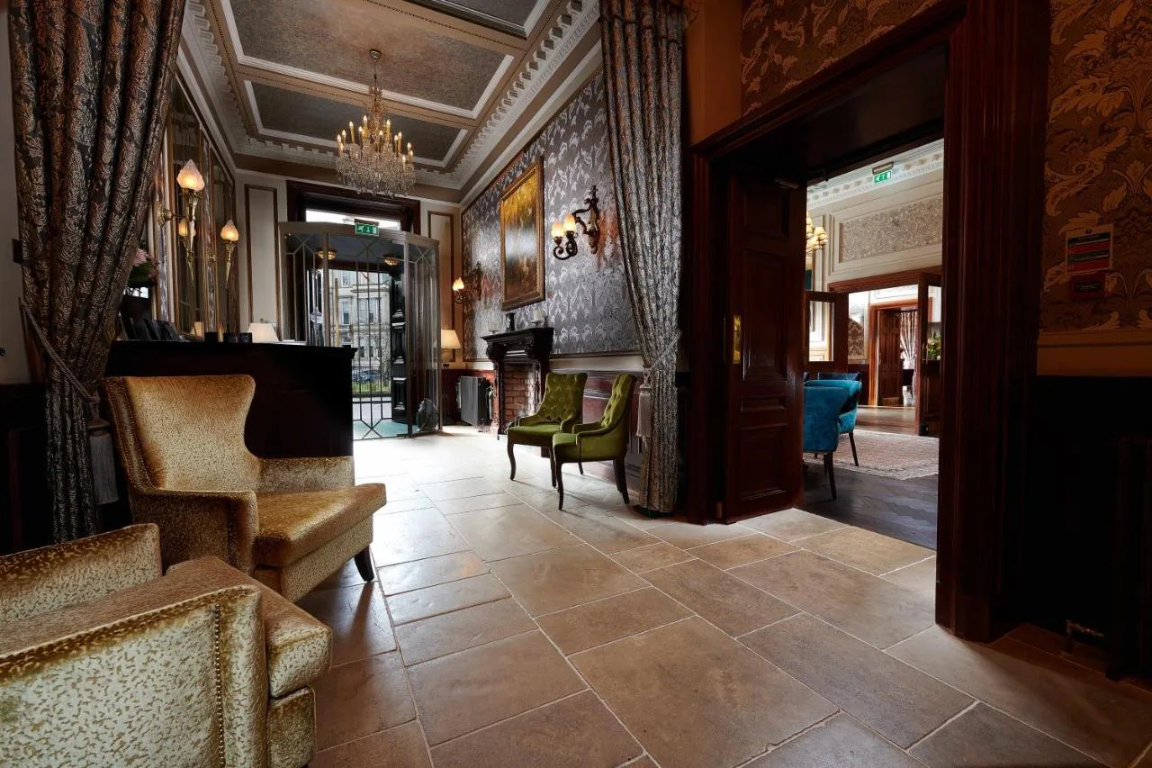 a living room with a lobby with chairs and a fireplace at The Bonham in Edinburgh
