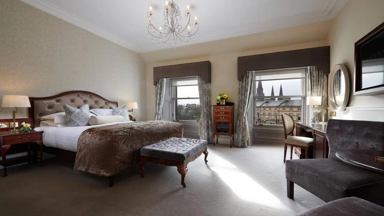 a bedroom with a large bed and a chandelier at The Bonham in Edinburgh