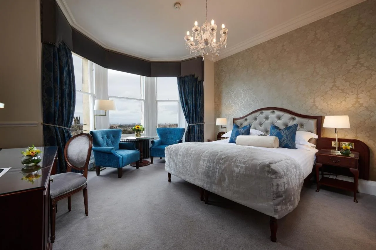 a bedroom with a bed and a table and chairs at The Bonham in Edinburgh